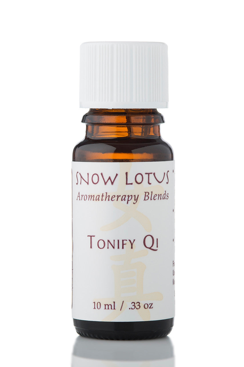 Snow Lotus Tonify Qi - Woman's Precious Blend in an amber glass bottle
