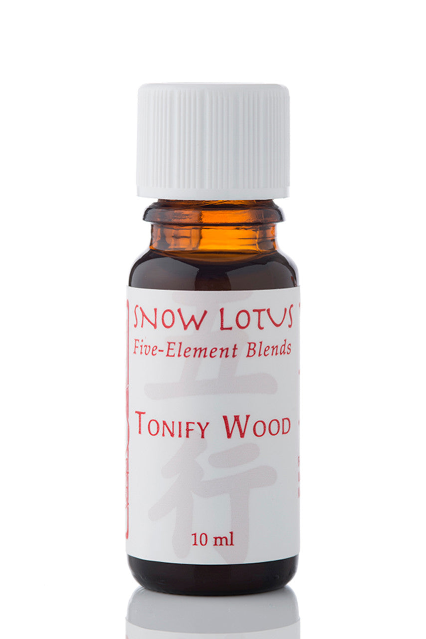 Snow Lotus Tonify Wood - Five Element Essential Oil Blend in an amber glass bottle