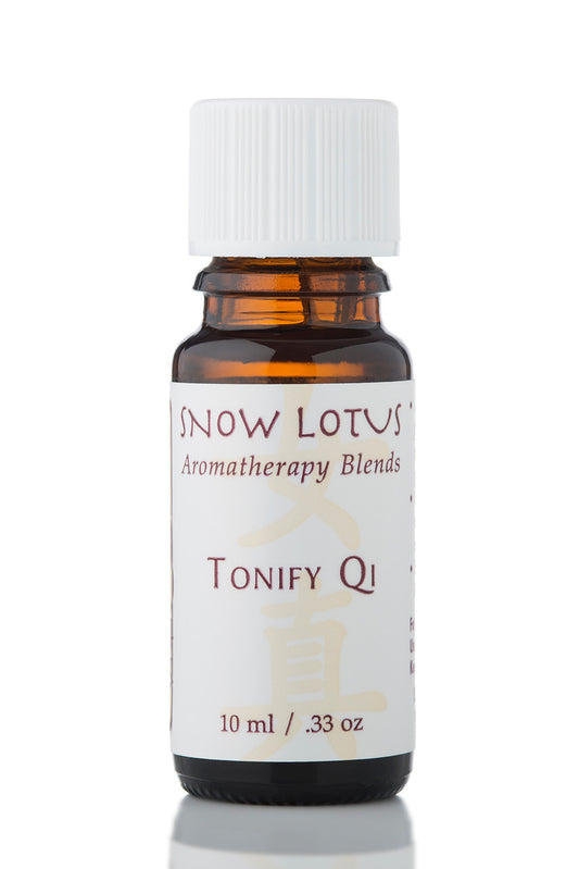 Snow Lotus Tonify Qi - Woman's Precious Blend in an amber glass bottle