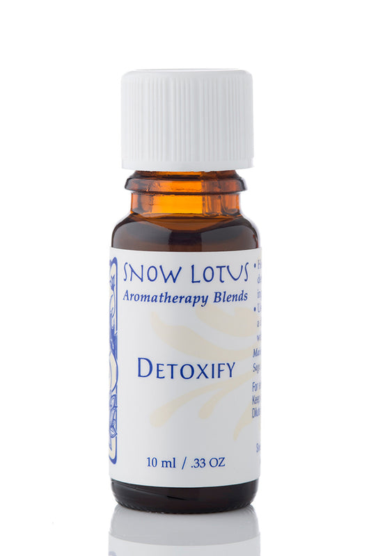 Snow Lotus Detoxify - Therapeutic Essential Oil Blend in an amber glass bottle