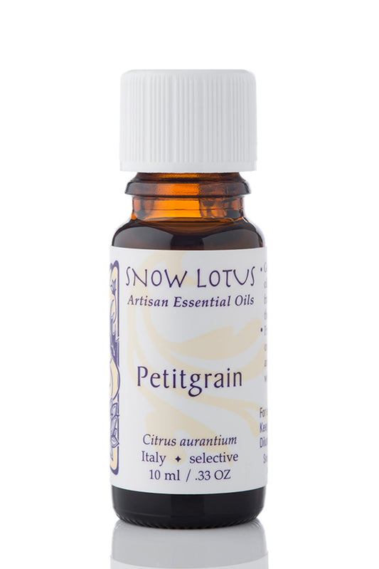 Snow Lotus Petitgrain Essential Oil in an amber glass bottle