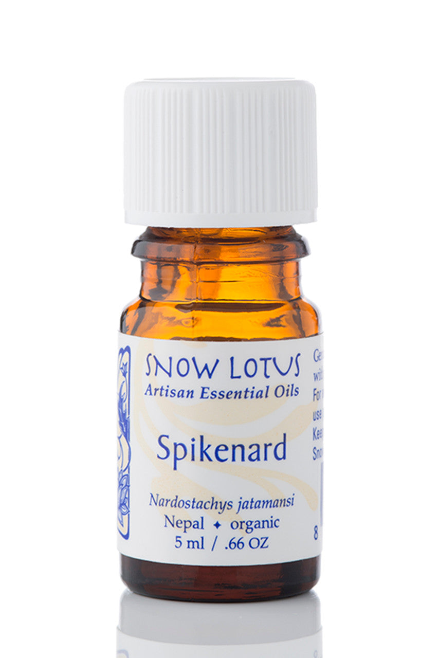 Snow Lotus Spikenard Essential Oil in an amber glass bottle