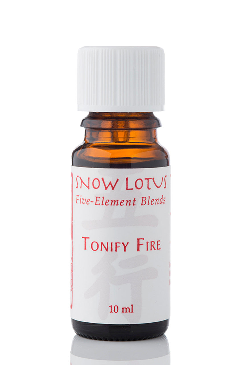 Snow Lotus Tonify Fire - Five Element Essential Oil Blend in an amber glass bottle