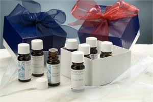 Gift sets tied with blue and red ribbon, shown with essential oil bottles